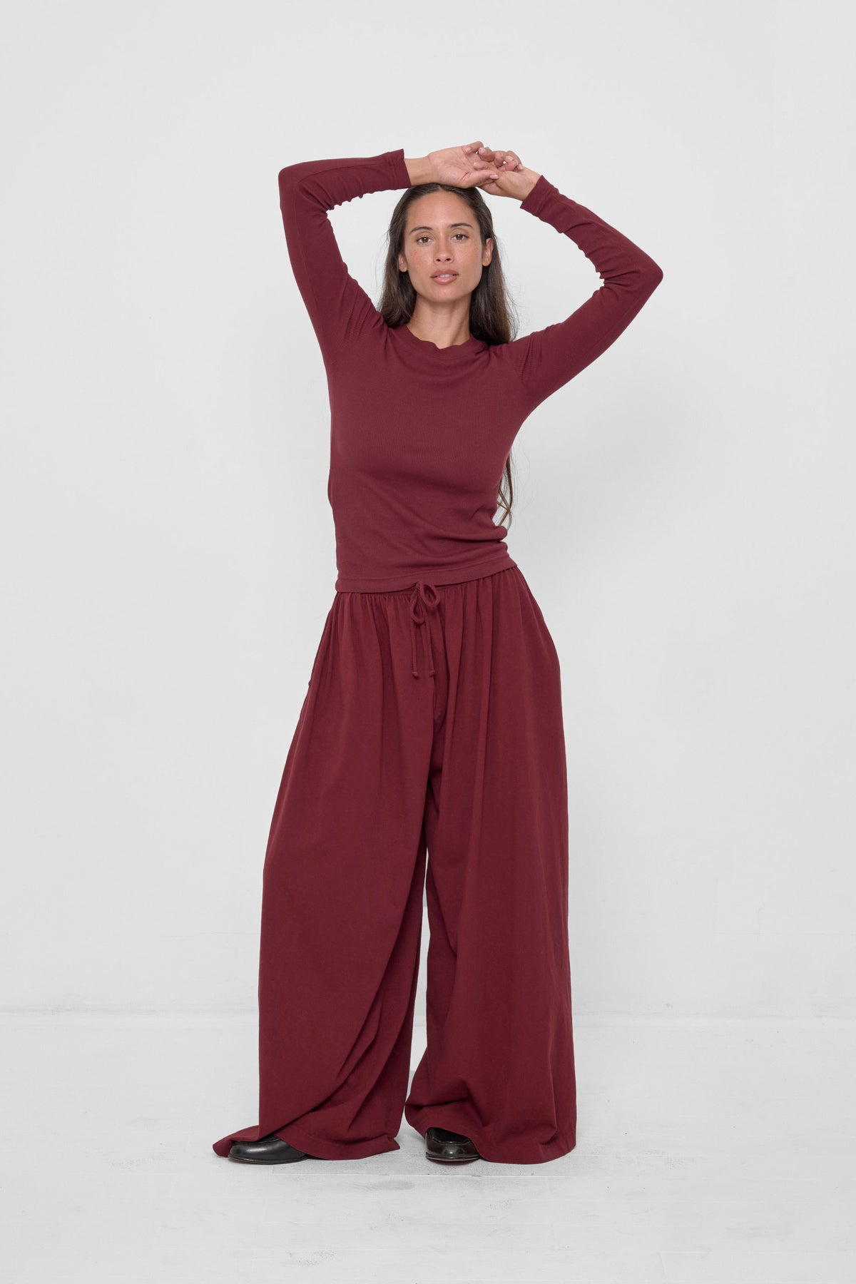 Tubular Pants in Garnet – front view on model, styled with matching Rib Long Sleeve