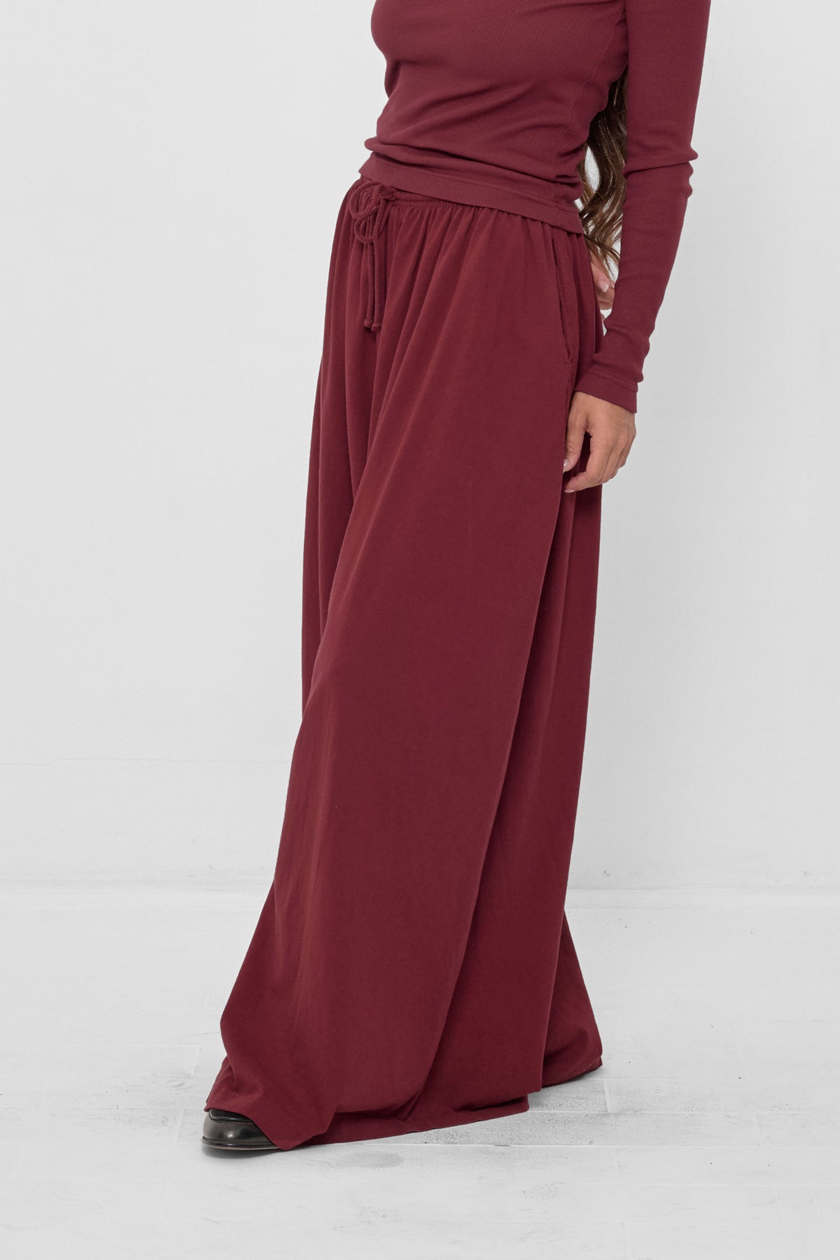 Tubular Pants in Garnet – 3/4 front view on model