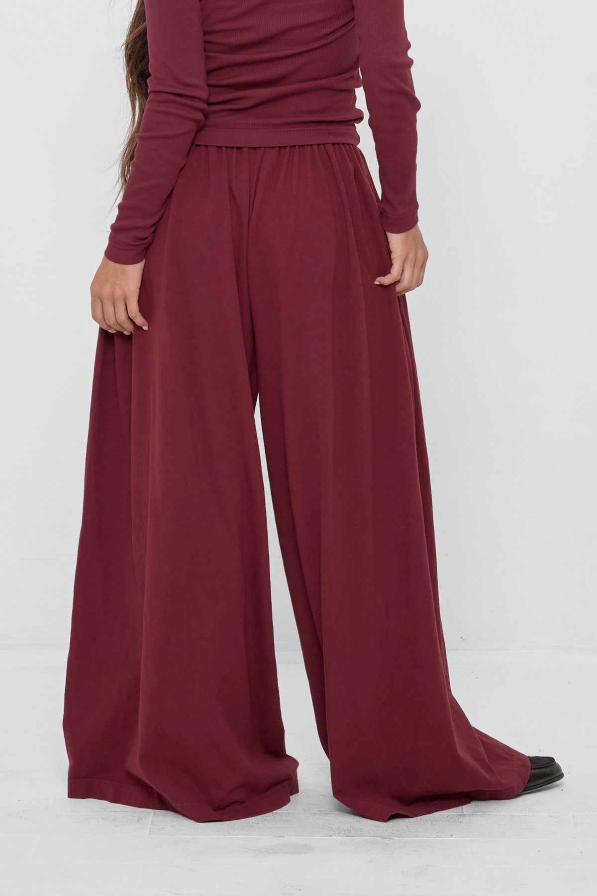 Tubular Pants in Garnet – back view on model
