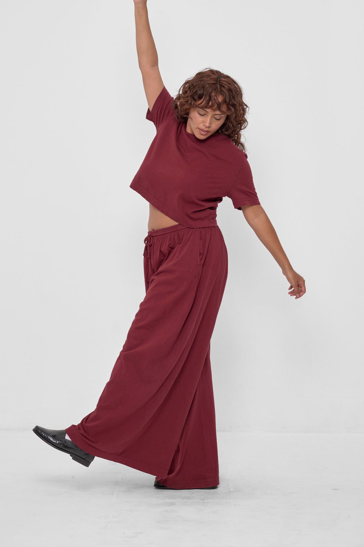 Tubular Pants in Garnet – front view on model, styled with matching Baby Trash Tee