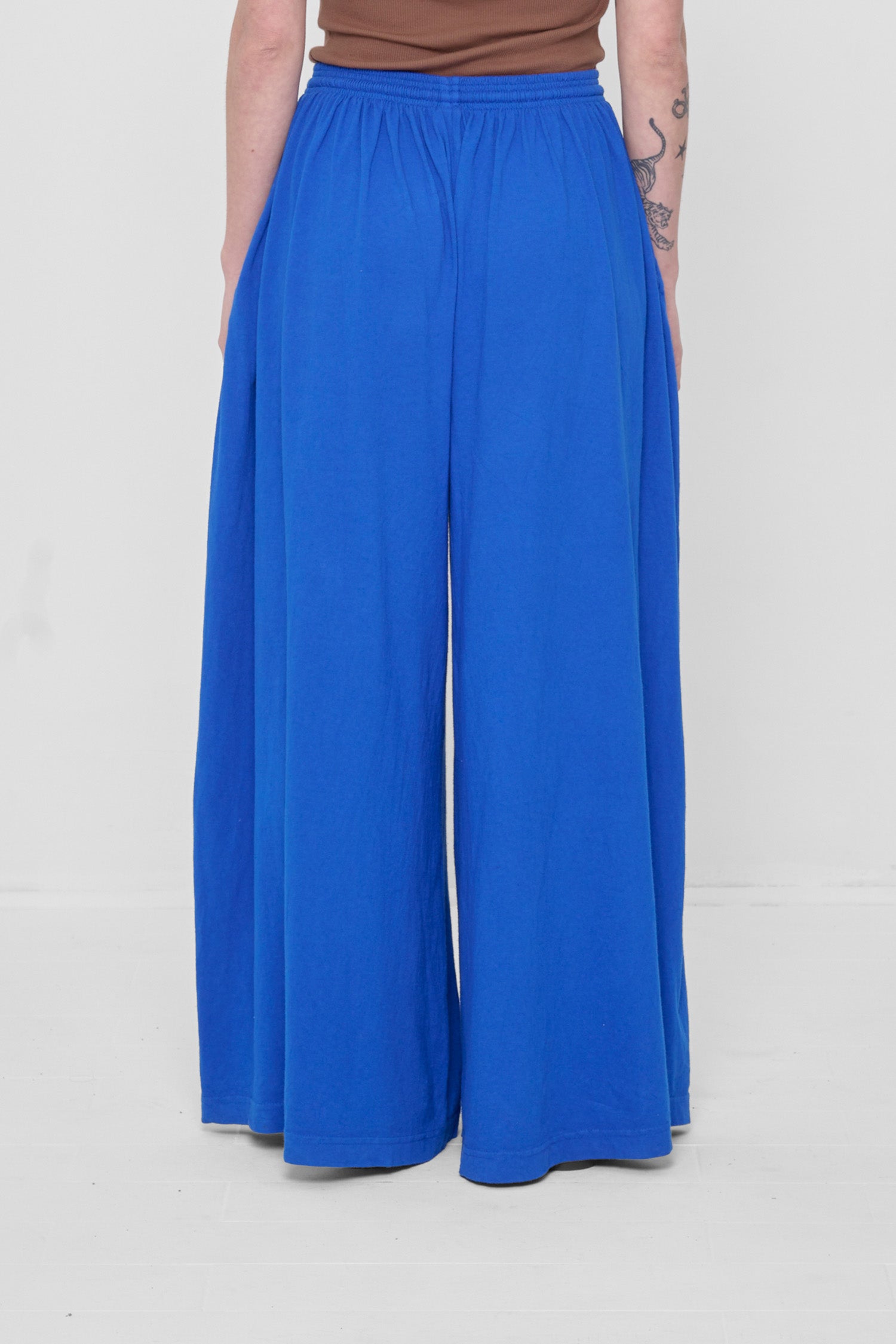 Back view showing flowing vertical fabric folds.