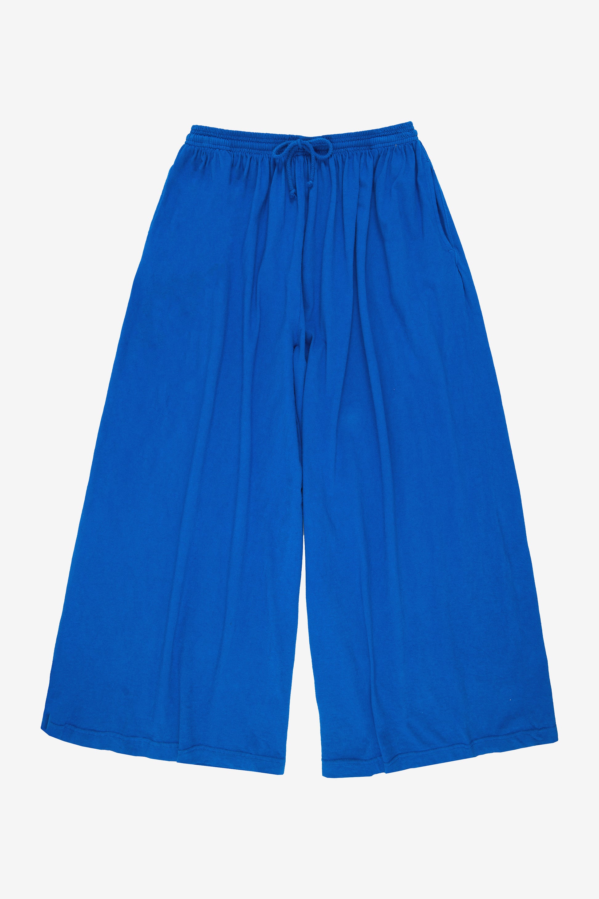 Flat lay: pant legs smoothed out, showing pant leg opening is as wide as the waistband.