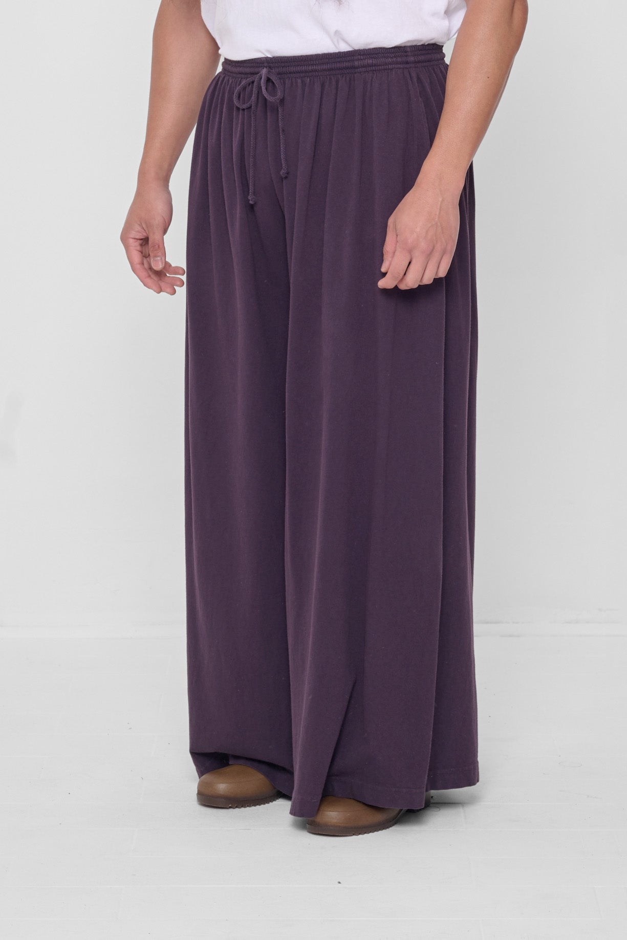 3/4 front view showing lack of side seams and flowing wide pant legs.