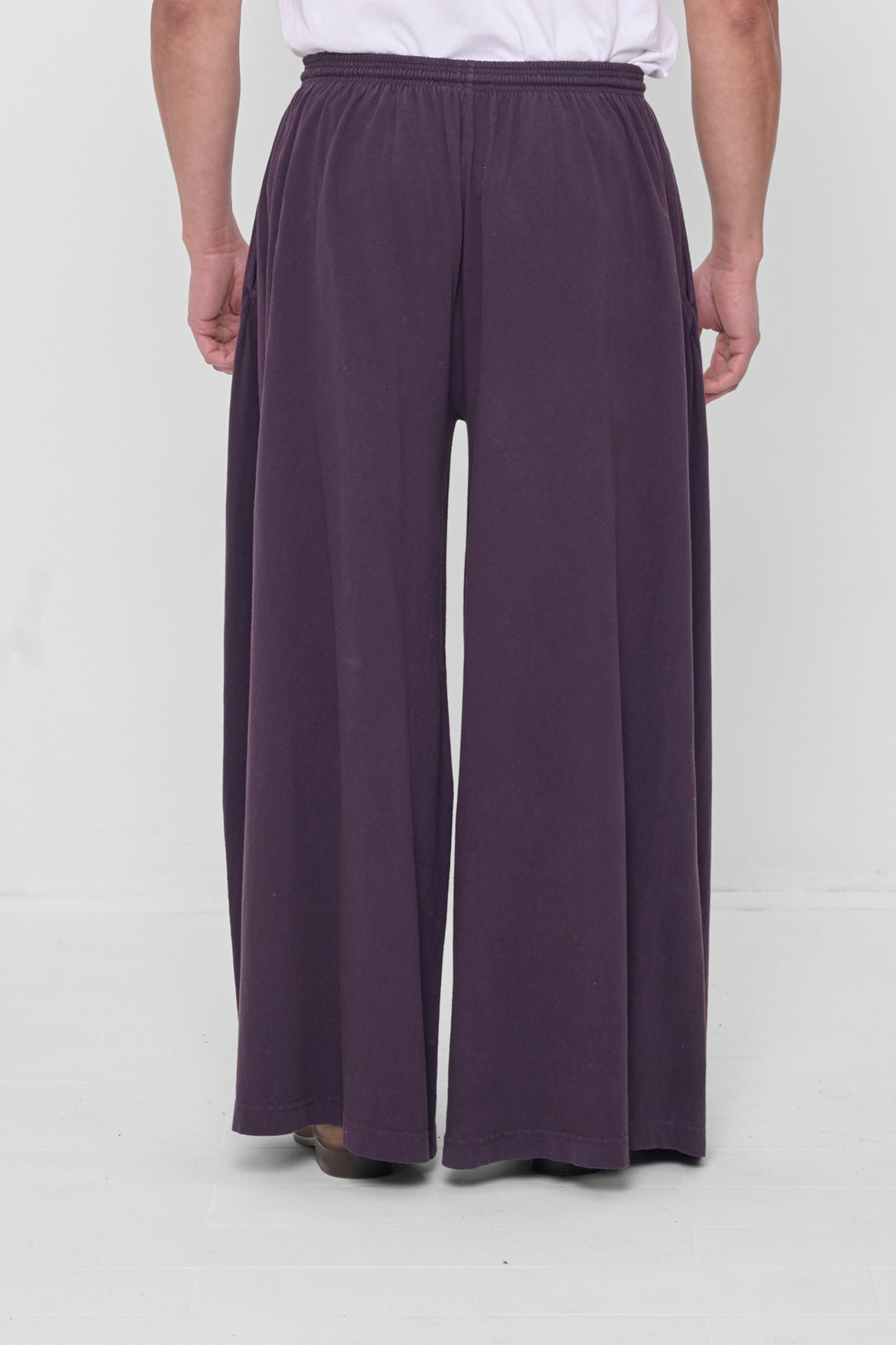 Back view showing flowing vertical fabric folds.