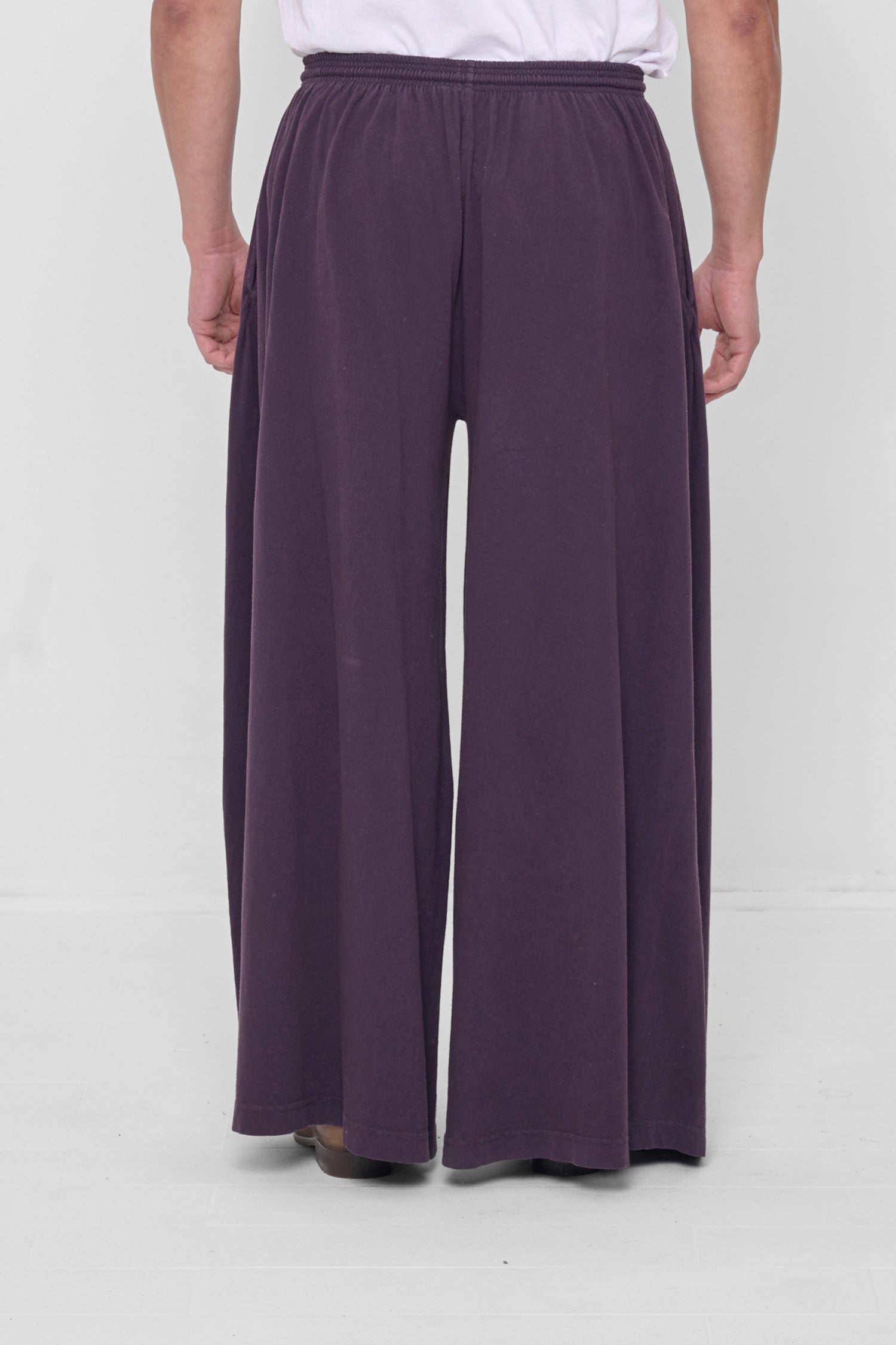 Back view showing flowing vertical fabric folds.