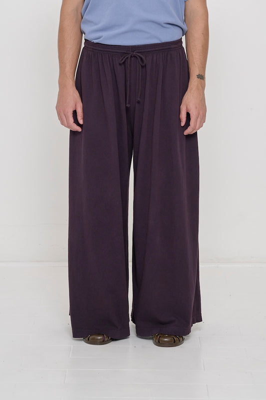Front view of a person in Mulberry Tubular Pants, featuring elastic waistband, drawcord, relaxed drape.
