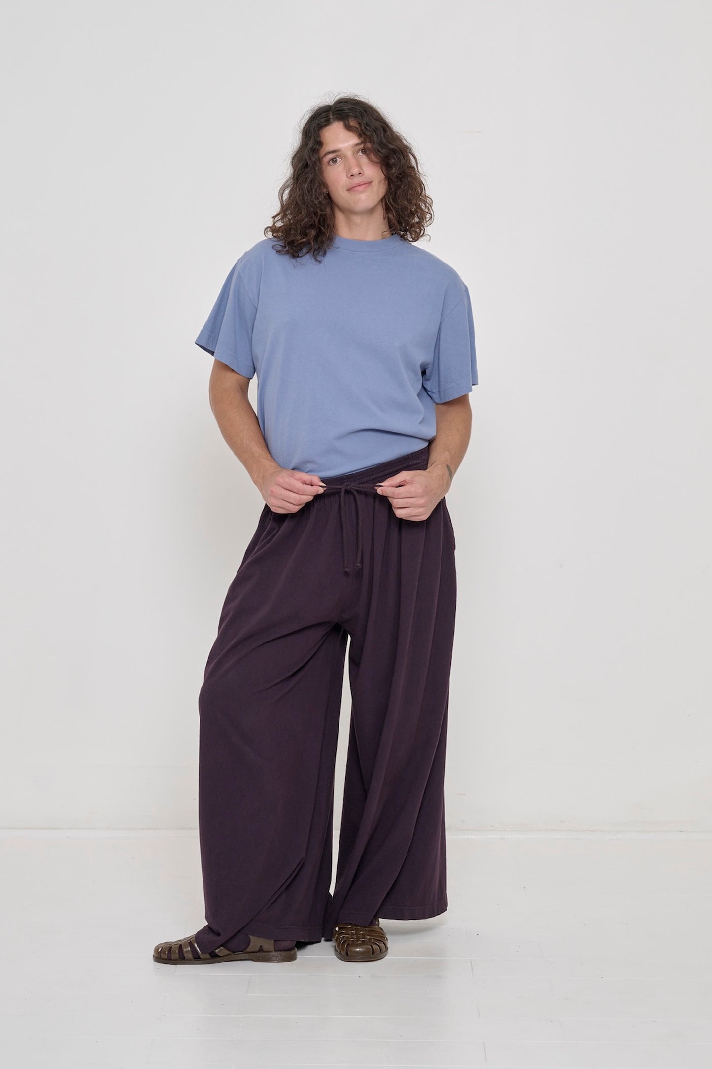 A person wearing Mulberry Tubular Pants and Periwinkle Boxier Trash Tee tucked in.