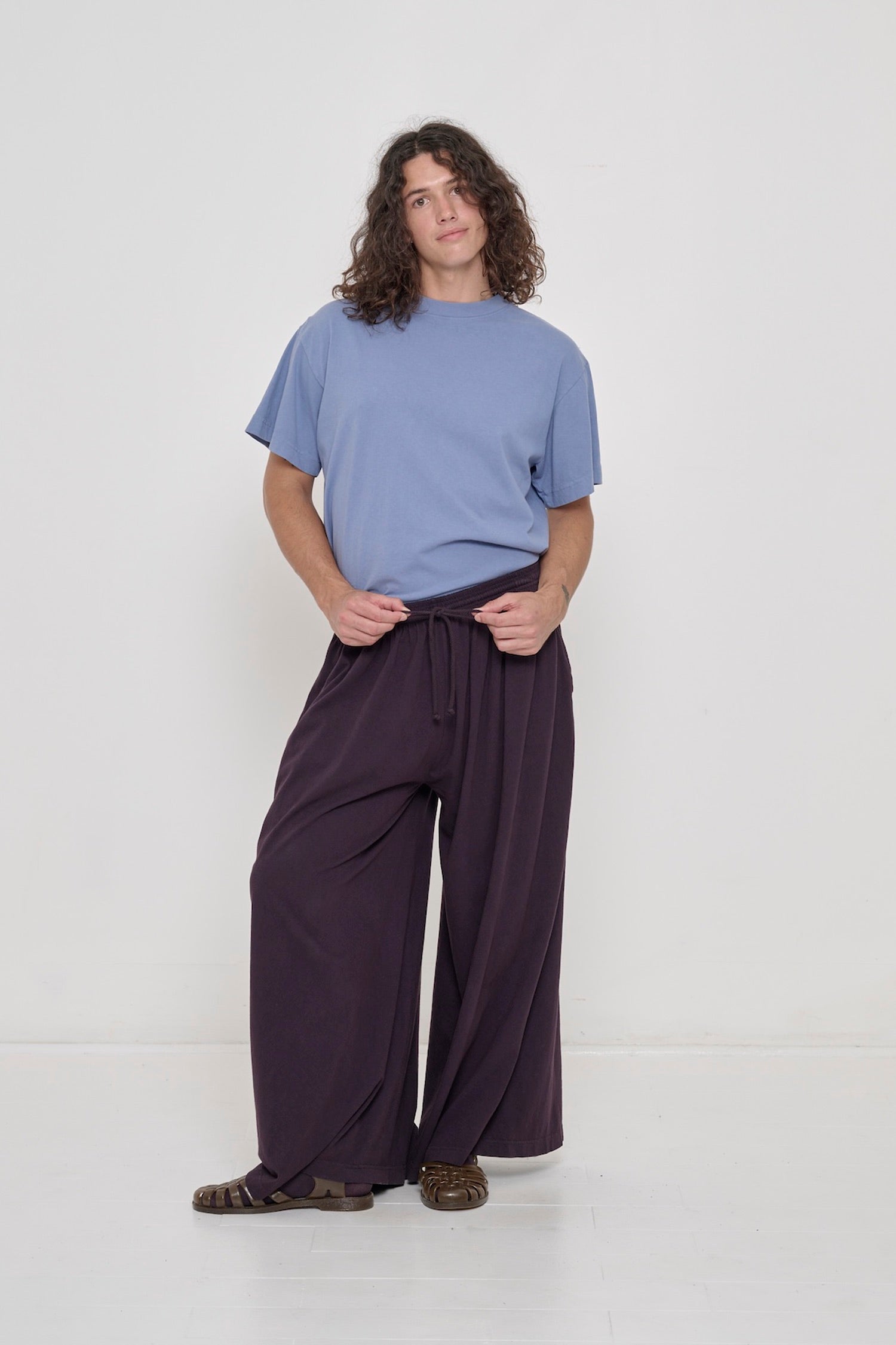 A person wearing Mulberry Tubular Pants and Periwinkle Boxier Trash Tee tucked in.