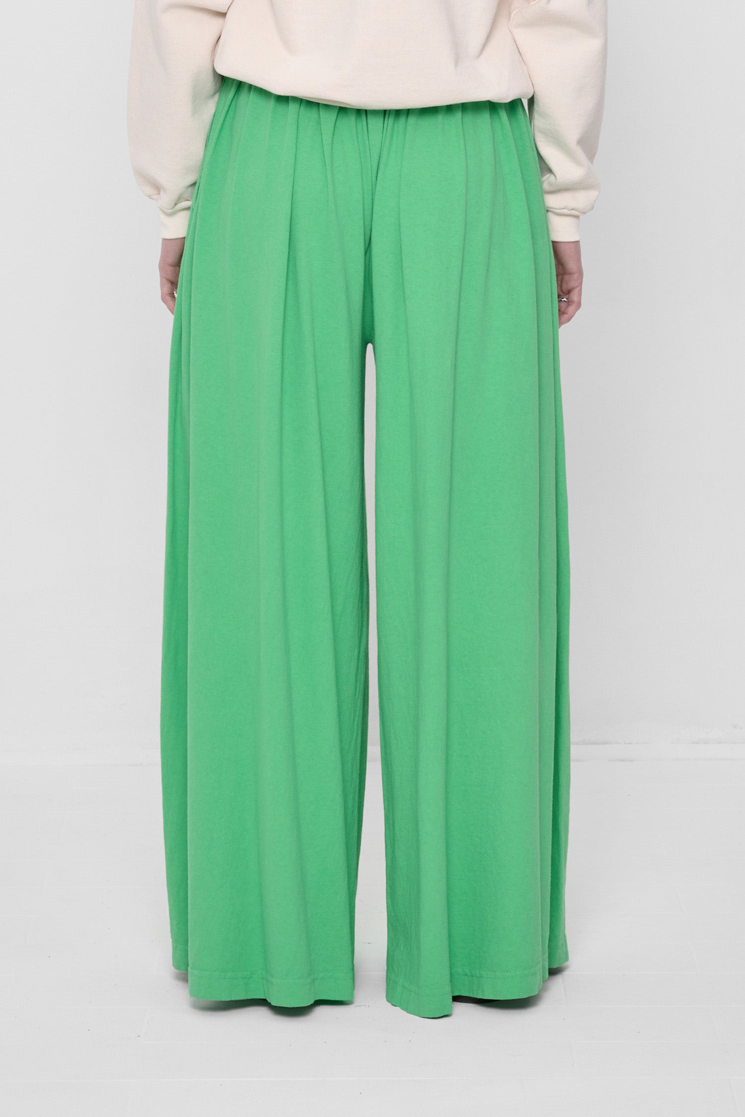 Back view showing flowing vertical fabric folds.