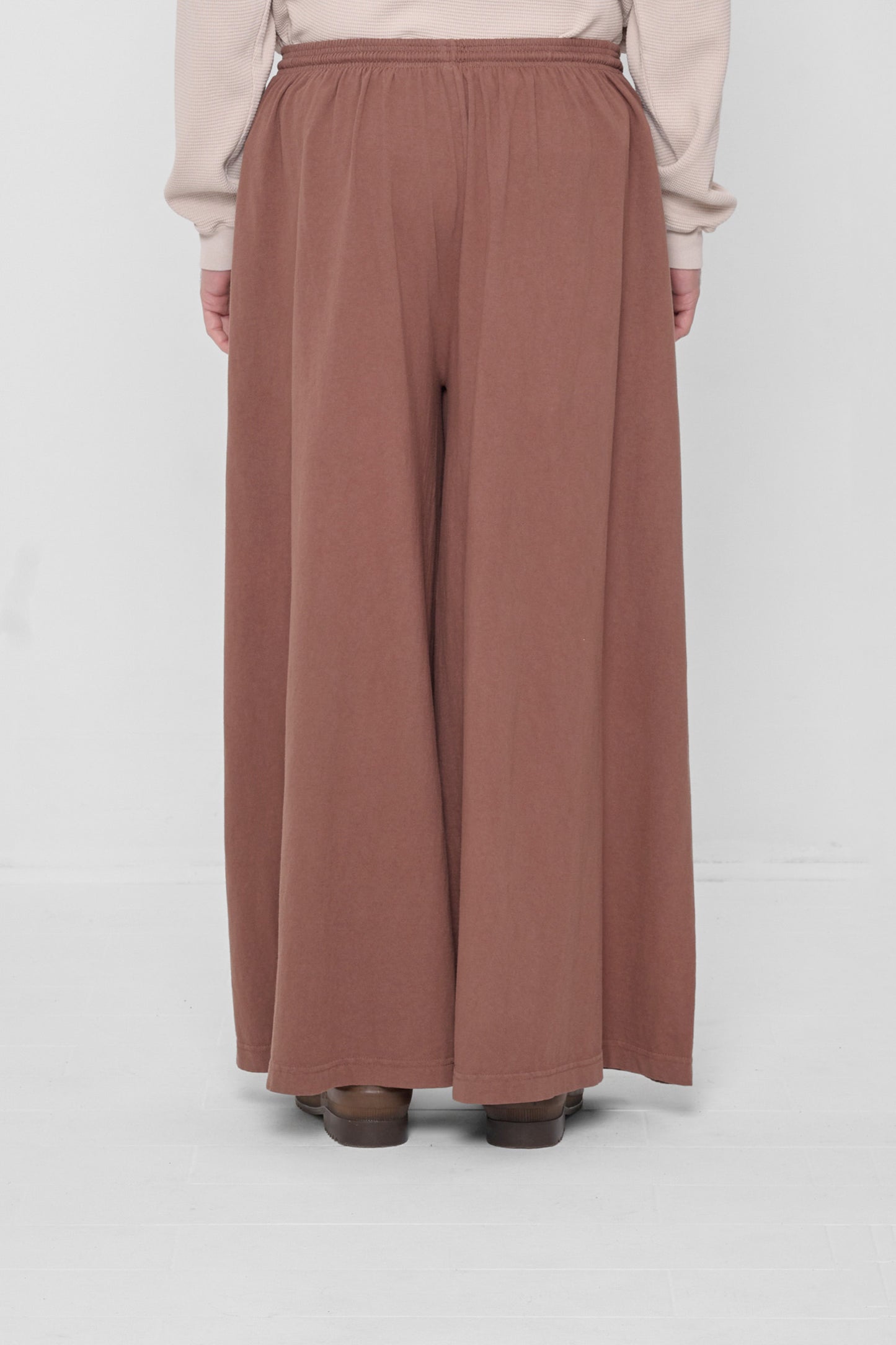 Back view showing flowing vertical fabric folds.