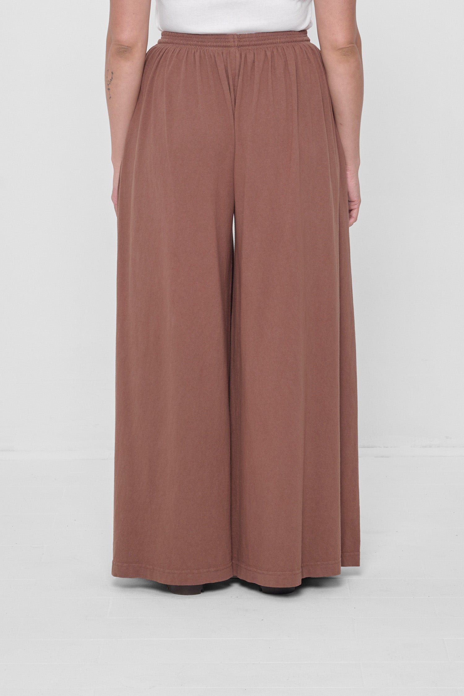 Back view showing flowing vertical fabric folds.