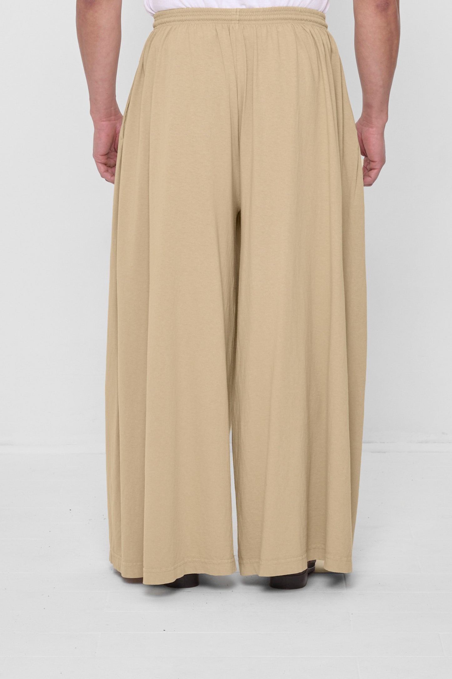 Back view showing flowing vertical fabric folds.