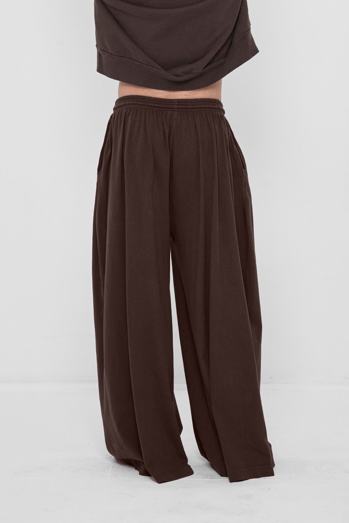 Tubular Pants in Wet Soil – back view on model