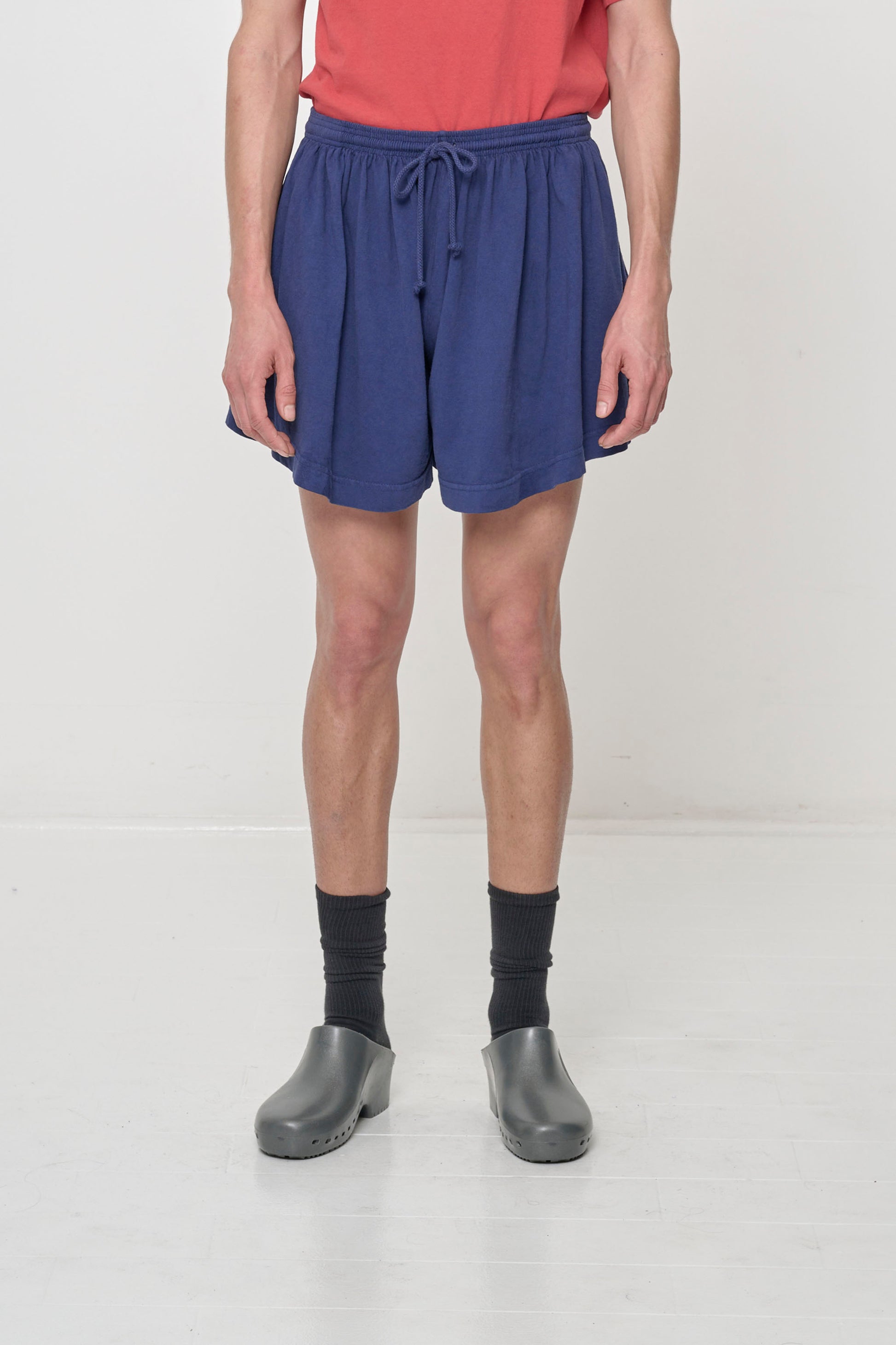 A 5'11" person in Washed Navy Tubular Shorts. Front hem at mid thigh and gets shorter at the sides.