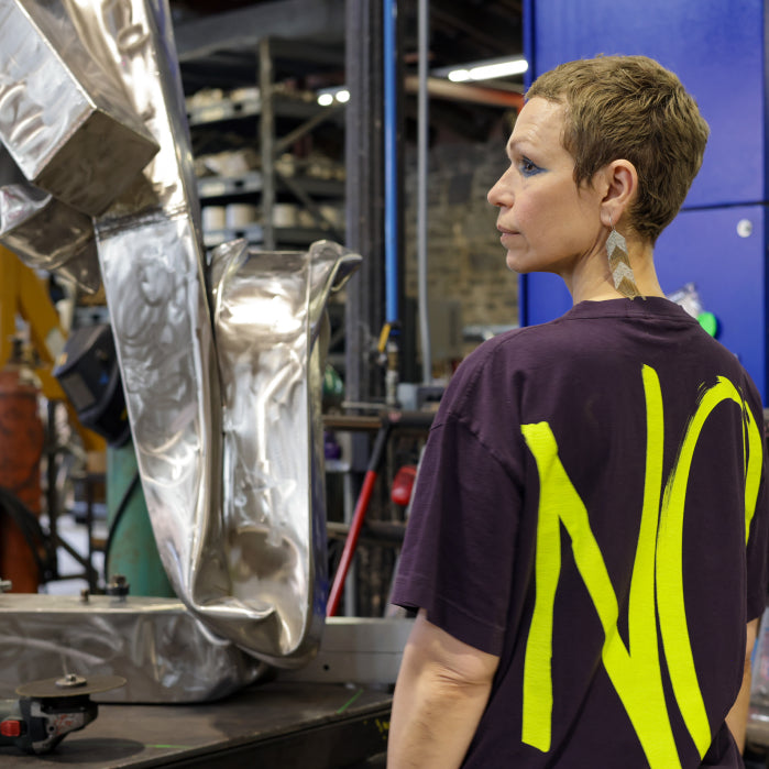 Back view of Carol Bove at her studio. Photo by Thomas Dozol.