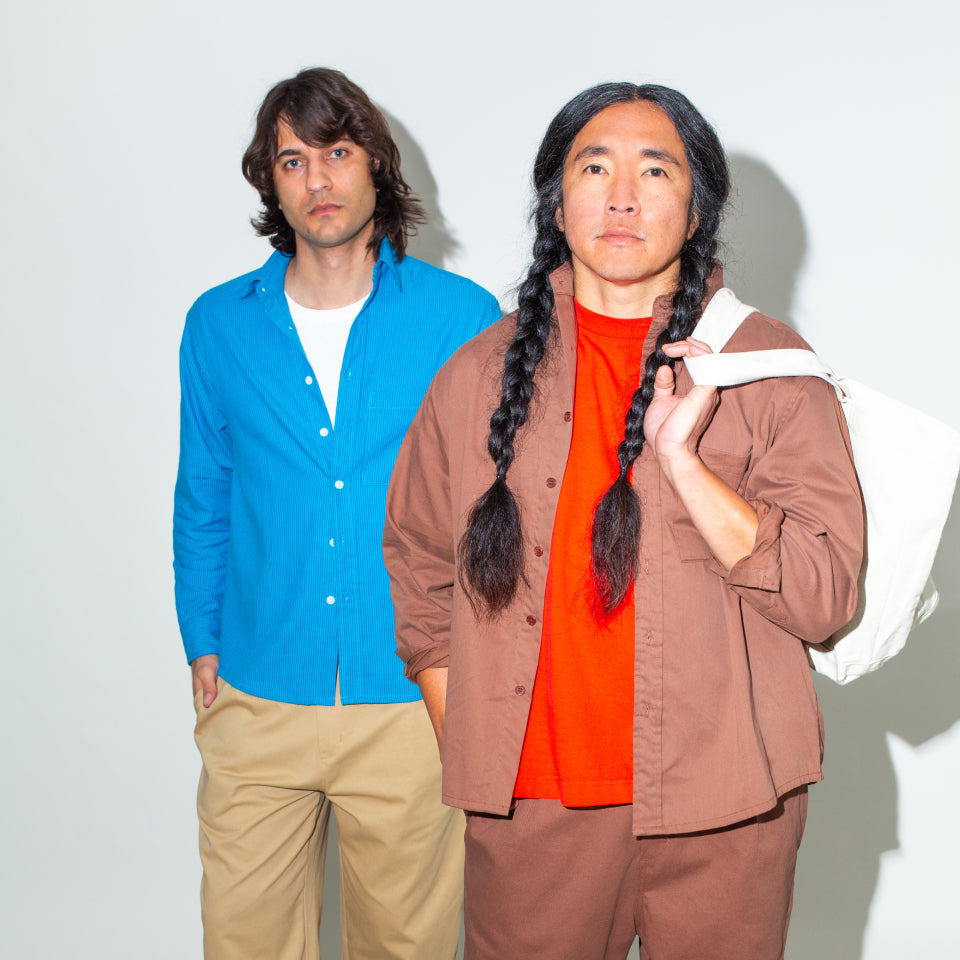 Two men standing side by side against a plain background wearing Prakash's perfect Button-Up Shirt